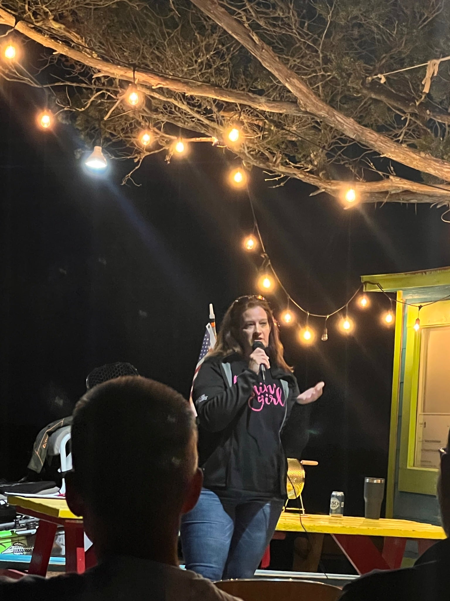 Cathy Sanders speaking wearing a Fishin' Girl black and pink t-shirt